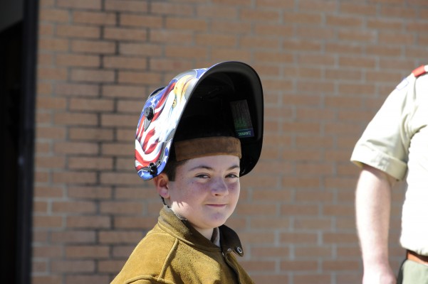 Scout wearing welding helmet