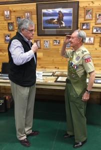 81-year-old Harry Persons Jr. salutes longtime friend Jim Scarbrough after receiving the Eagle Scout award. (Photo credit: Karen Murphy/Times-Enterprise)